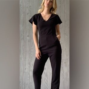 Black dressy jumper with ruffle sleeves and pocket